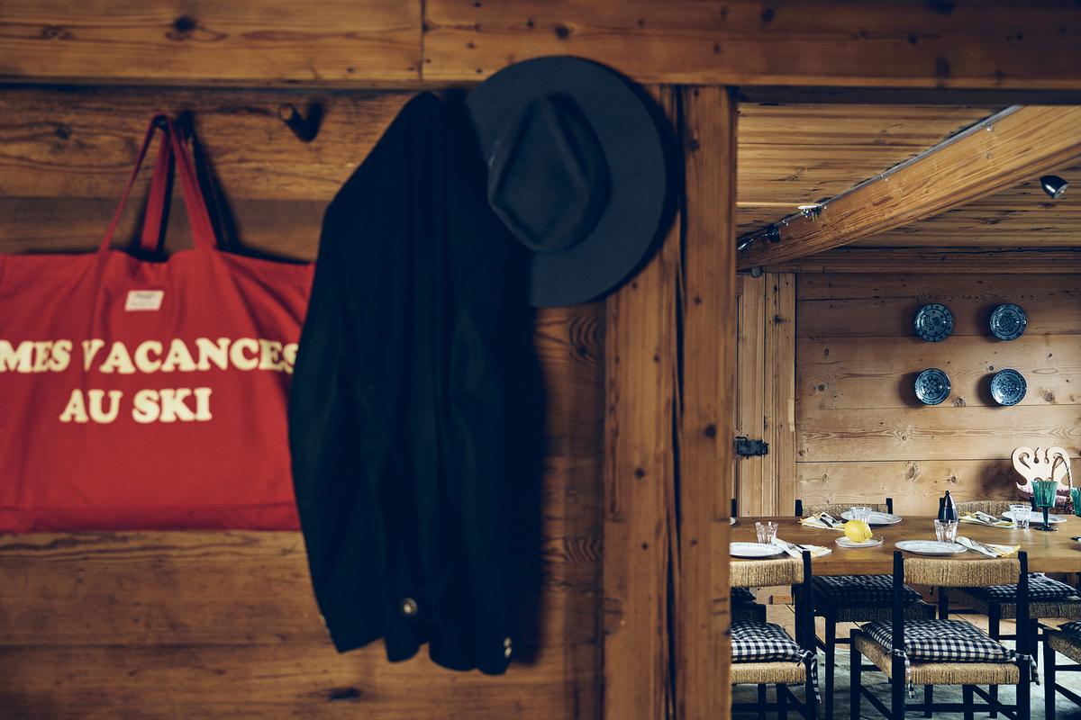 84-club-chalet-bag-jacket-hat-on-the-hanger-open-door-served-table