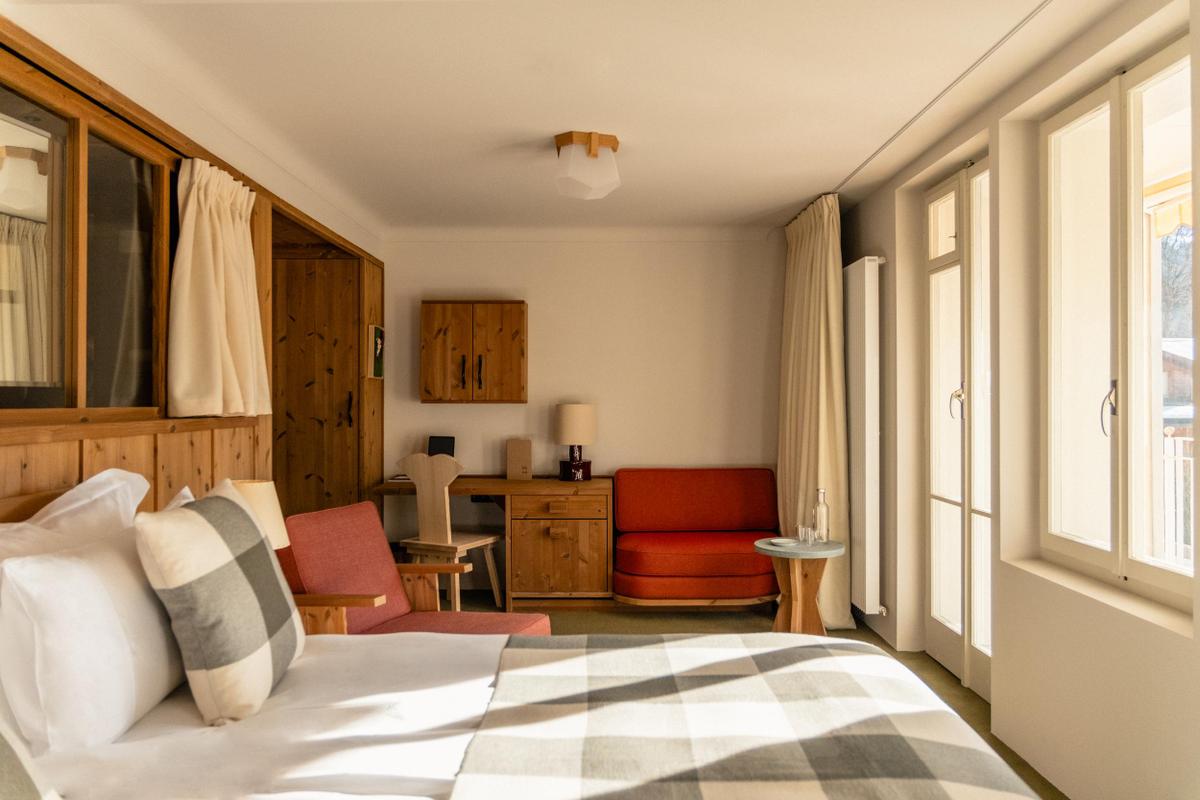 Grand Hotel Belvedere room with striped bedding and red chair